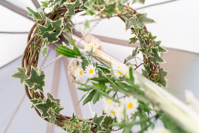 Flower wreath inside a bell tent.